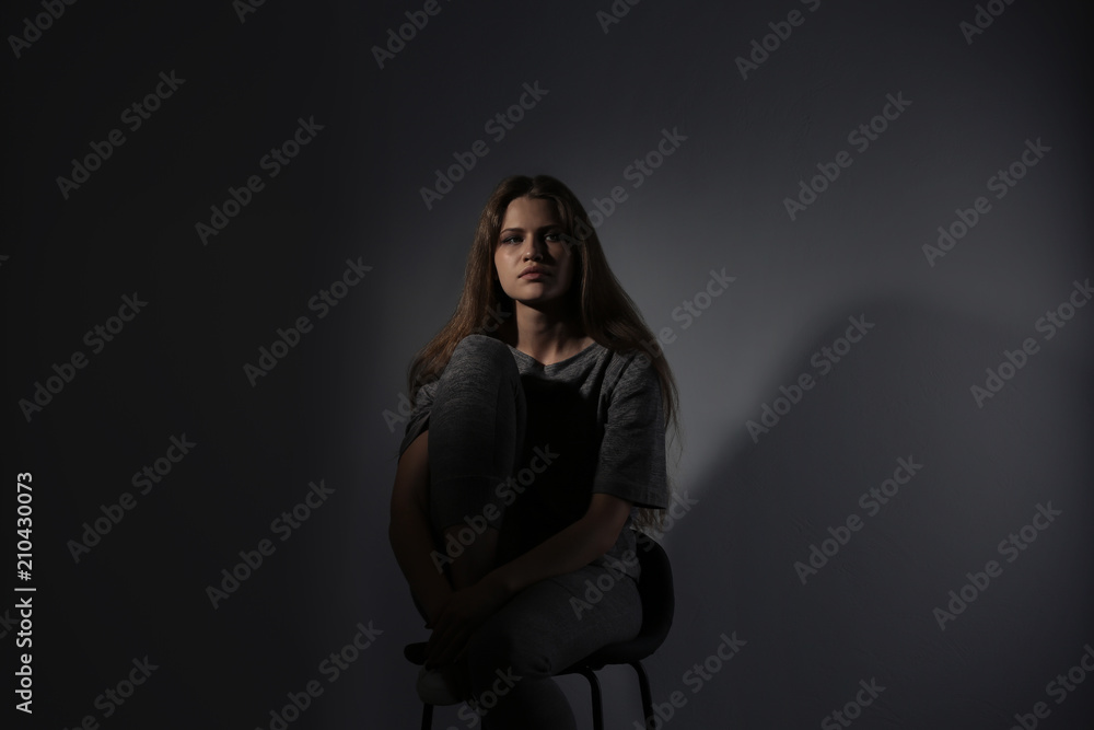 Depressed young woman on gray background Depressed young woman on gray background