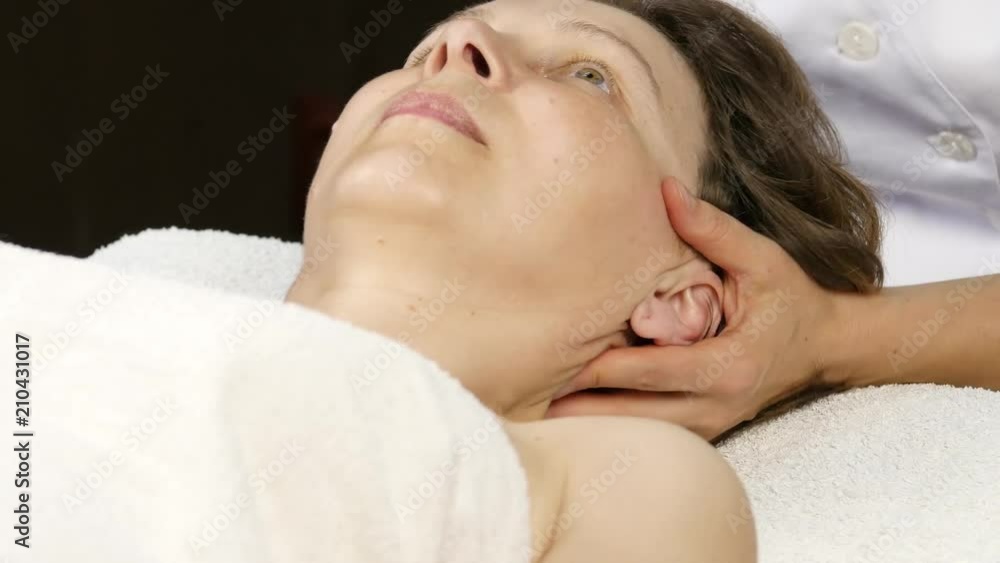 head massage at spa center. client enjoys the services of a massage therapist head massage at spa center. client enjoys the services of a massage therapist