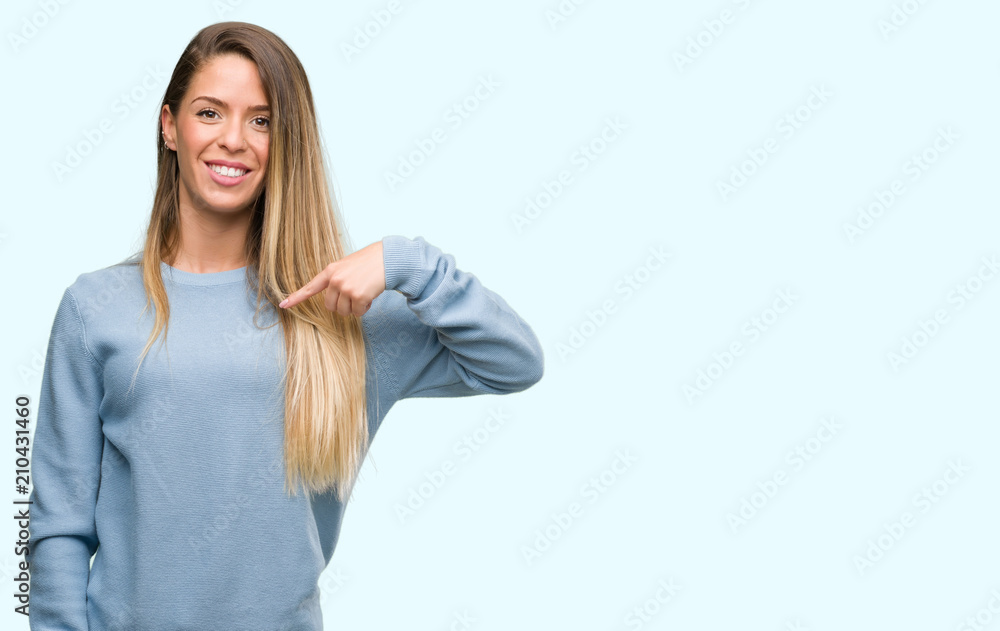 Beautiful young woman wearing sweater and jeans with surprise face pointing finger to himself Beautiful young woman wearing sweater and jeans with surprise face pointing finger to himself