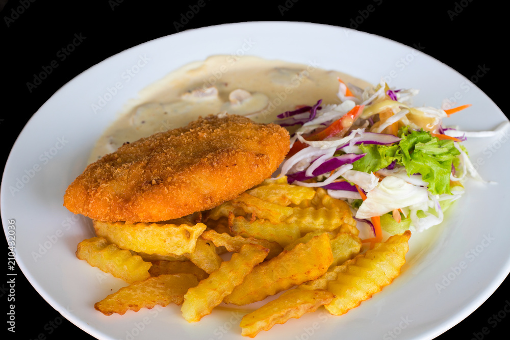 Schnitzel cutlet with potato and salad. Fried chicken cutlet top view photo on wooden table Schnitzel cutlet with potato and salad. Fried chicken cutlet top view photo on wooden table