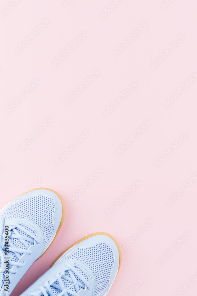 Violet female sneakers on pink background. Flat lay, minimal background. Violet female sneakers on pink background. Flat lay, minimal background.