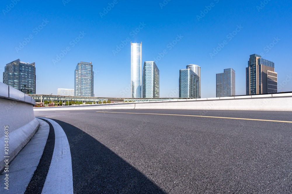 empty asphalt road with modern office building in urban