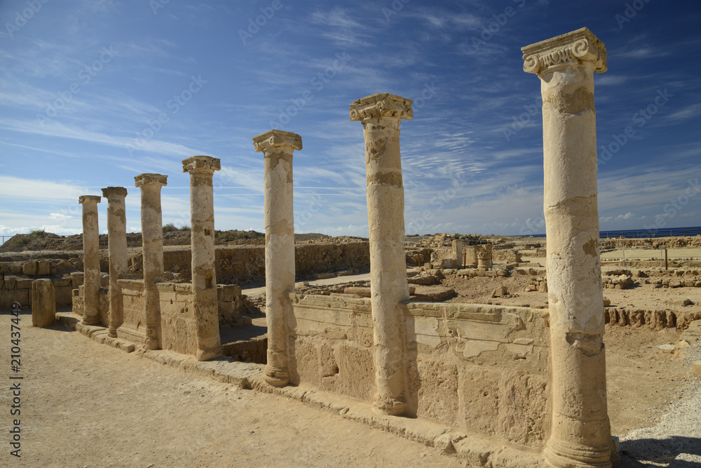 Row of ancient columns against blue sky background