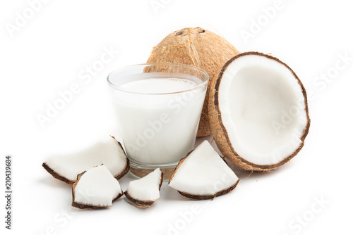 coconut oil and fresh coconuts isolated on white background