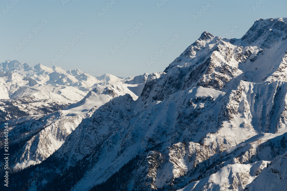 Steep slopes of the snowy mountain massif in Sochi, Russia