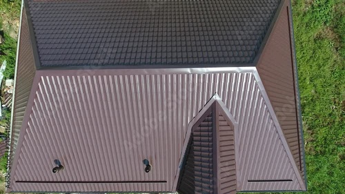 Roofing of metal profile wavy shape. The roof of corrugated sheet. A view from above on the roof of the house