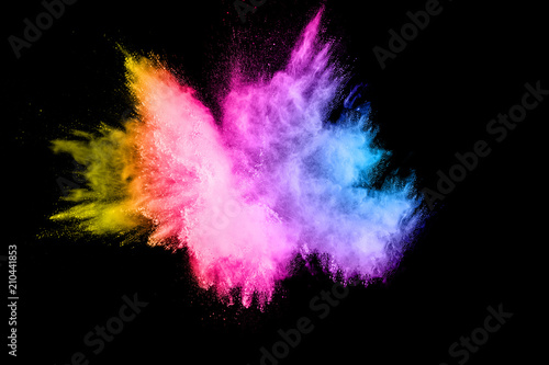 color powder explosion cloud isolated on black background. Freeze motion of color dust particles splashing.