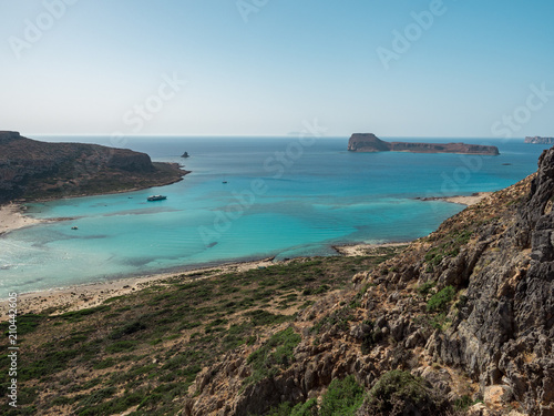 Beautiful Balos lagoon on Crete island, Greece. Tourists relax and bath in crystal clear water of Balos beach. June, 2018