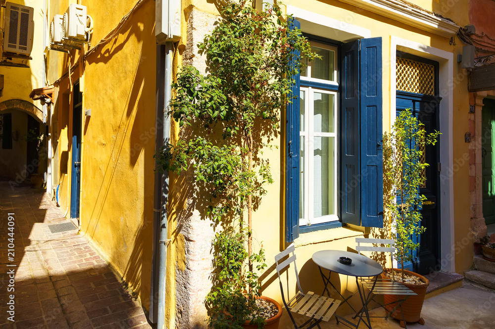 Obraz premium Beautiful street with colorful buildings in evening soft sunlight in Chania, Crete island, Greece.