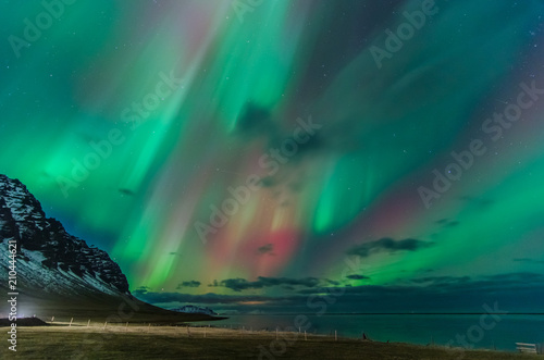 Fotografie Colorful northern lights over iceland sky