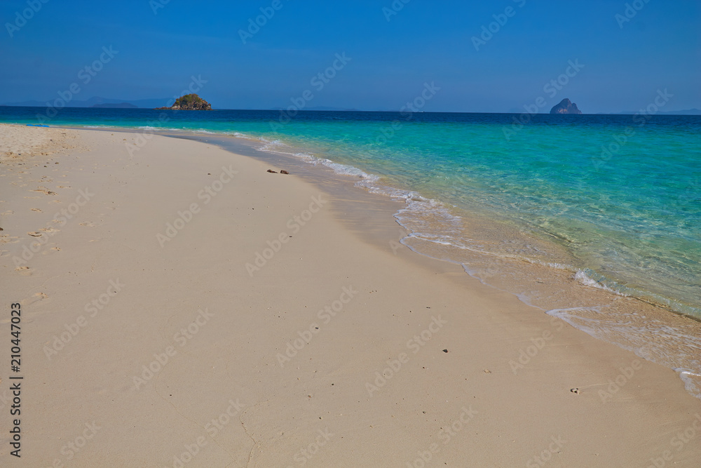 Sea coast, beach with white sand, clear turquoise sea water Sea coast, beach with white sand, clear turquoise sea water
