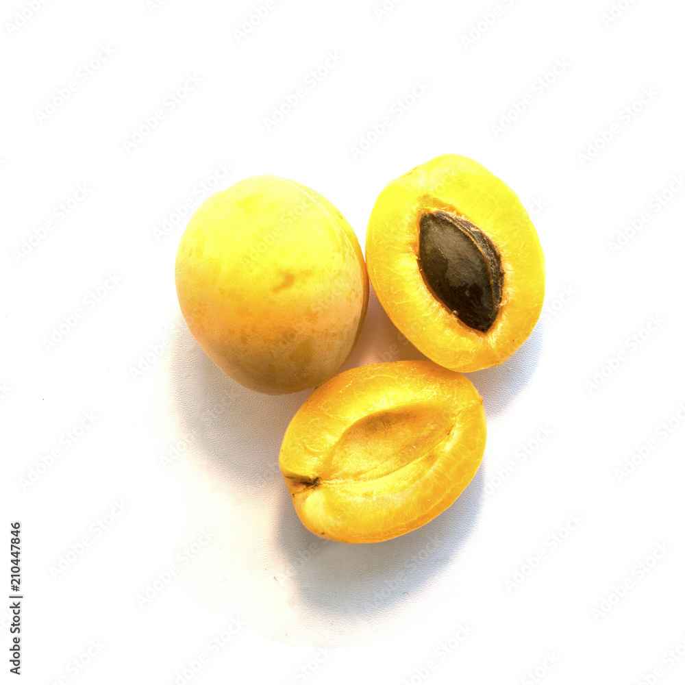 Three appetizing apricots on a white background. Top view.
