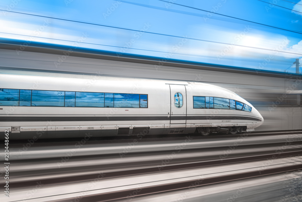 The high speed train rushes through the city by rail