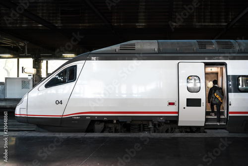 The tourist on boarding a high-speed train at a railway station