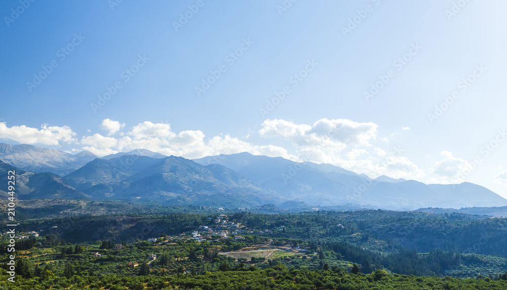 Countryside. View of the valley, village and mountains in the distance on a cloudy evening Greece, island Crete .