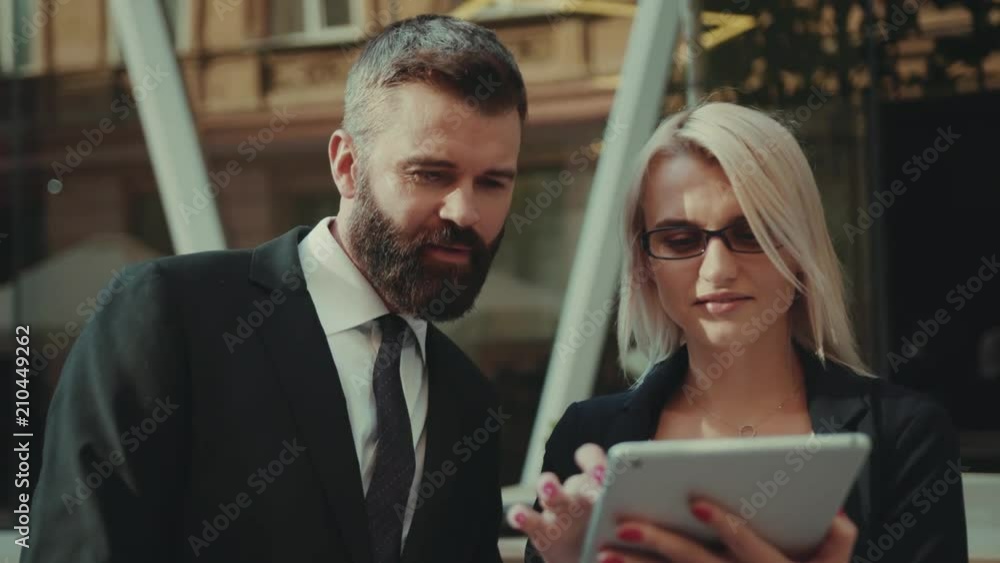 Business man and woman use of tablet computer together at outdoor talk handsome internet office technology tablet, pair team standing corporate executive city outside urban work young teamwork worker Business man and woman use of tablet computer together at outdoor talk handsome internet office technology tablet, pair team standing corporate executive city outside urban work young teamwork worker