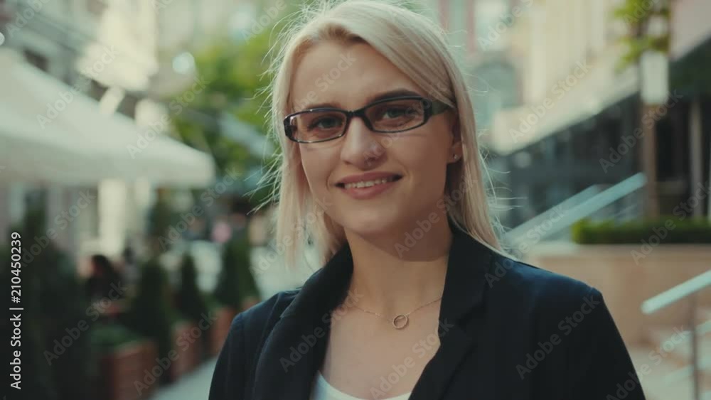 Attractive young woman with glasses use tablet computer look at camera feel happy smile blonde outdoor hair street fashion hand tree girl internet portrait technology sun spring city lady slow motion Attractive young woman with glasses use tablet computer look at camera feel happy smile blonde outdoor hair street fashion hand tree girl internet portrait technology sun spring city lady slow motion