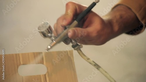 Full HD. Artist cleaning airbrush. Close-up photo