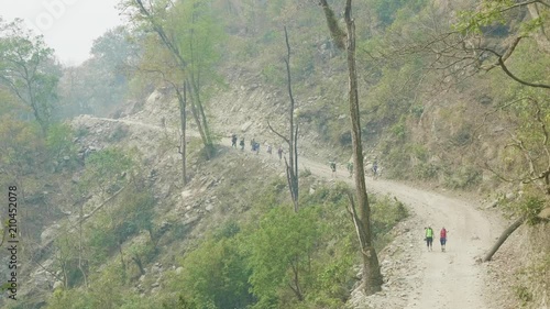 Backpackers on the alpine path on the Manaslu mountain circuit trek in Nepal. photo