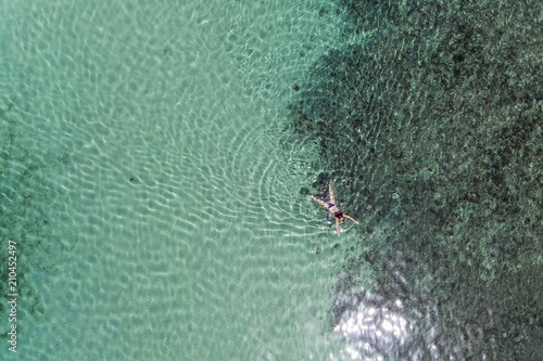 Aerial view of a girl swimming in the sea