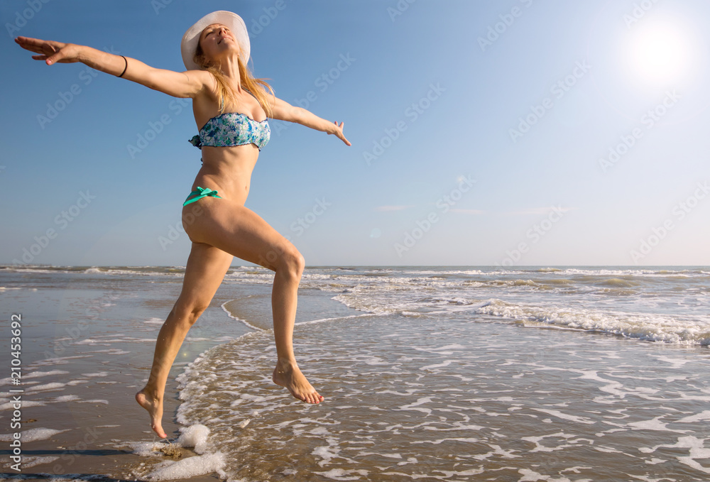 beautiful woman jump on the beach in the sea beautiful woman jump on the beach in the sea