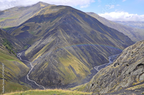 Mountain landscape with a rainbow and small rivers