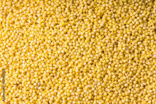 Closeup of yellow millet grains for background or texture.