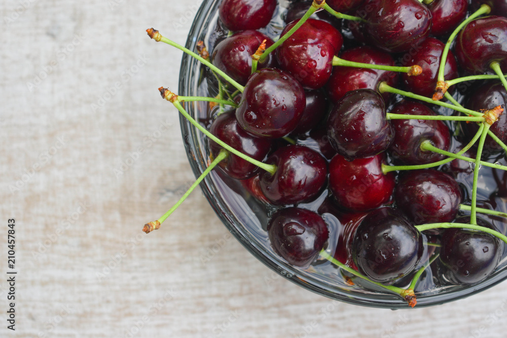 Spelled cherries on the white wooden background Spelled cherries on the white wooden background