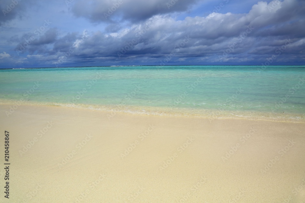 Gorgeous view of Indian Ocean, Maldives. White sand coast line, turquoise ocean water and blue sky with white clouds. Gorgeous nature landscape background.