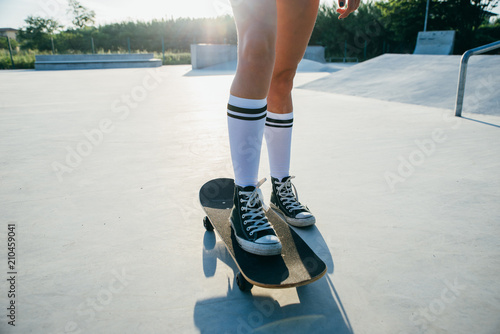 Beautiful skater girl lifestyle moments in a skatepark