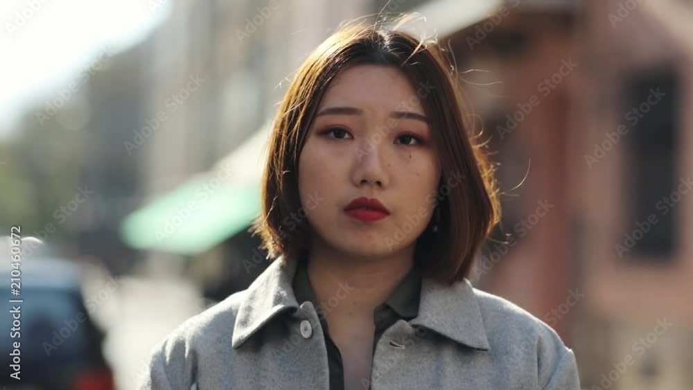 Close up serious face Asian woman look at camera sad outdoor girl eye asian beautiful beauty chinese expression fashion japanese portrait young attractive cute gorgeous hair slow motion Close up serious face Asian woman look at camera sad outdoor girl eye asian beautiful beauty chinese expression fashion japanese portrait young attractive cute gorgeous hair slow motion