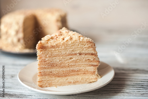 Beautiful appetizing homemade puff cake Napoleon. Piece of puff pastry on a white plate