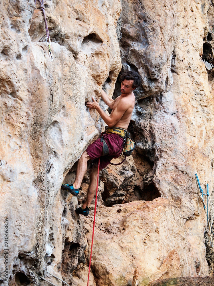 Young strong guy climbing / leading topless in Thailand - Krabi, Tonsai Beach Young strong guy climbing / leading topless in Thailand - Krabi, Tonsai Beach