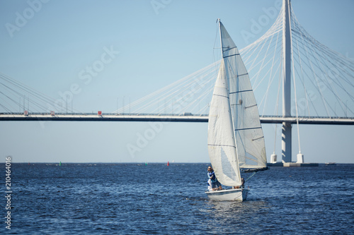 Active man sailing on yacht in the sea while enjoying summer vacation