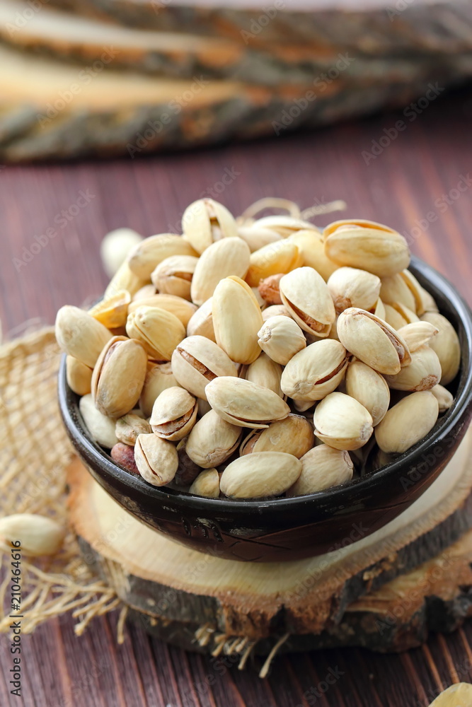 Pistachios nuts on wooden table. Pistachios nuts on wooden table.