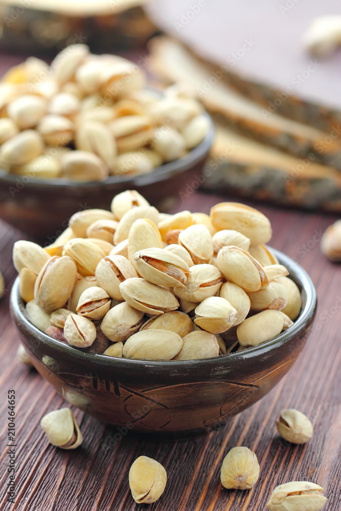 Pistachios nuts on wooden table. Pistachios nuts on wooden table.
