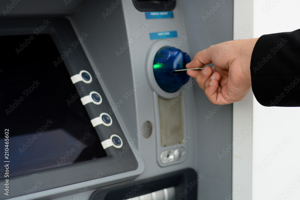 Business man put his credit card at the ATM Business man put his credit card at the ATM