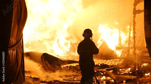 One Firefighter In Front Of A Burning Building