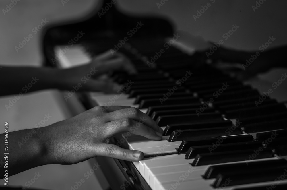Fototapeta premium Hands on black and white piano keys