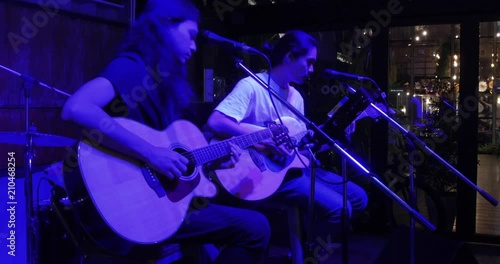 Musician in the restaurant. Bangkok, Thailand. musician play and sing the music for customer to come have dinner in the restaurant at night.