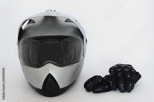 Fotografie Motocross, Enduro – gray helmet with closed visor and black Moto gloves on white