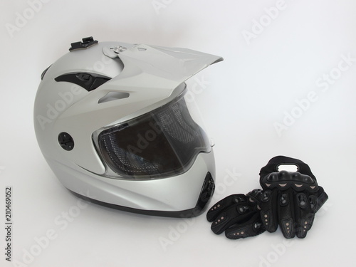 Obraz na płótnie Motocross, Enduro – gray helmet with closed visor and black Moto gloves on white