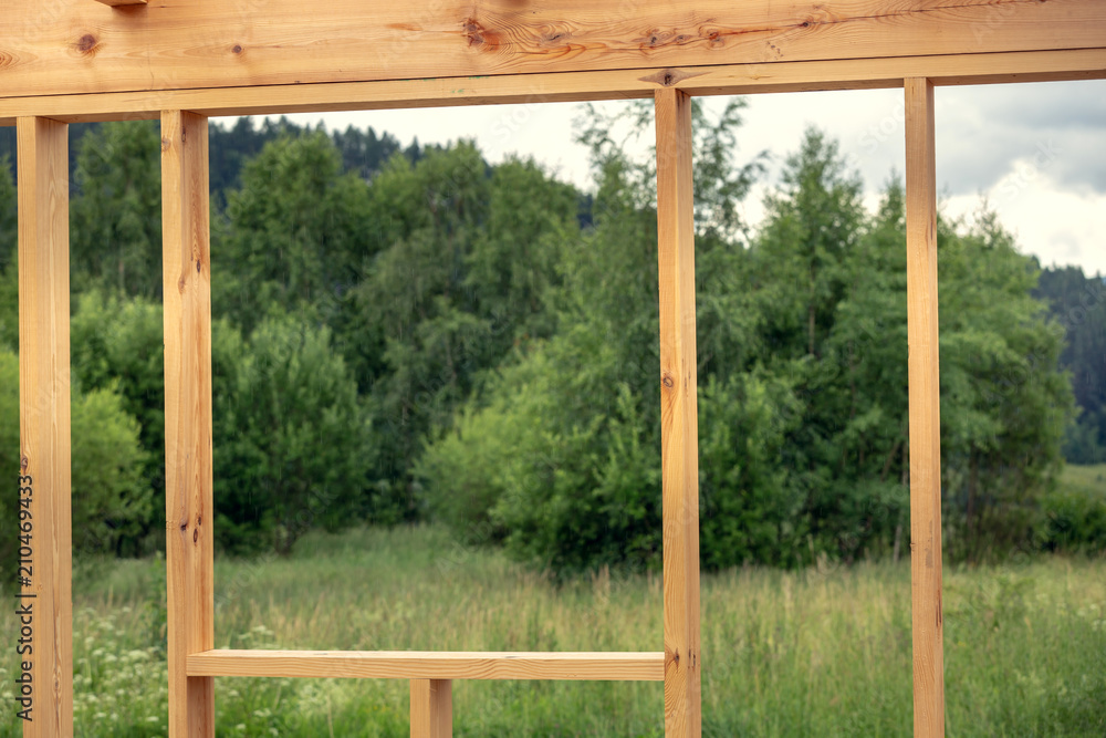 Wooden construction of an unfinished house. Skeleton of a building made of beams. Wooden construction of an unfinished house. Skeleton of a building made of beams.