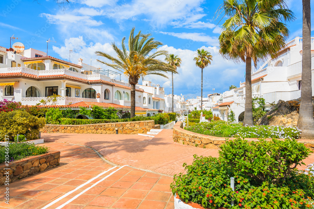 White houses and tropical plants in small coastal village near Marbella, Costa del Sol, Spain