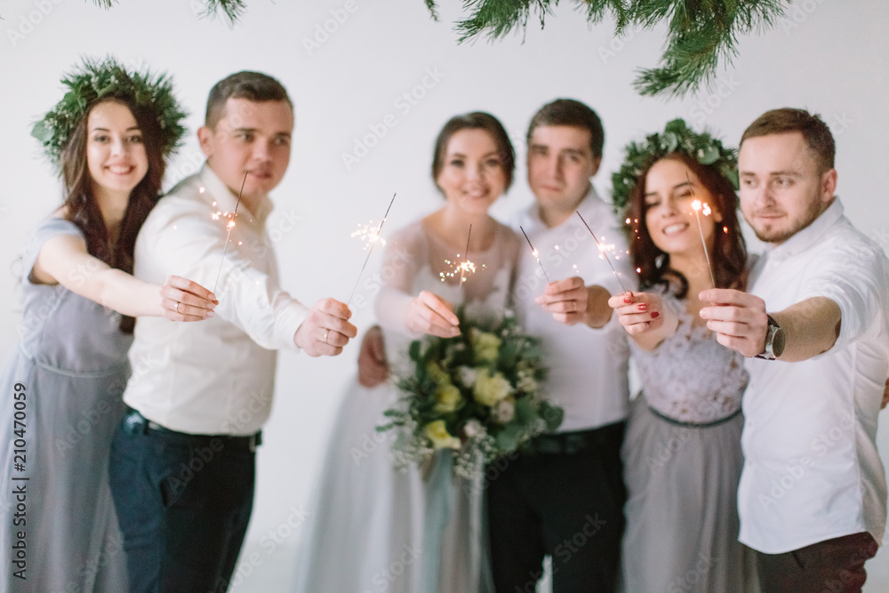Wedding couple bride and groom and their friends standing with Bengal fires and having fun Wedding couple bride and groom and their friends standing with Bengal fires and having fun