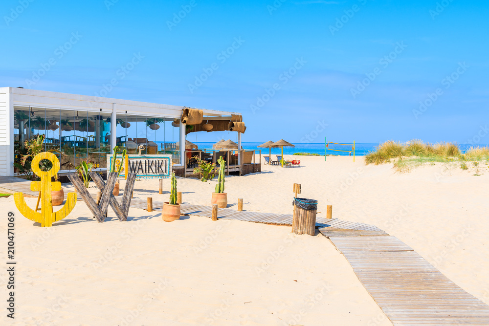 TARIFA BEACH, SPAIN - MAY 11, 2018: Restaurant on sandy beach on sunny beautiful day. Andalusia is hottest province of the country and attracts many tourists.