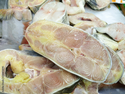 Raw sliced fish for seafood freezing in the ice at market.fresh sliced fish prepareation for cooking. photo