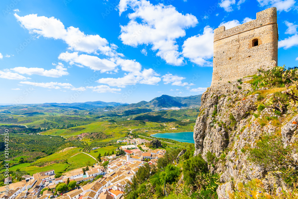 View of castle tower and Zahara de la Sierra village in spring season on sunny beautiful day, Andalusia, Spain
