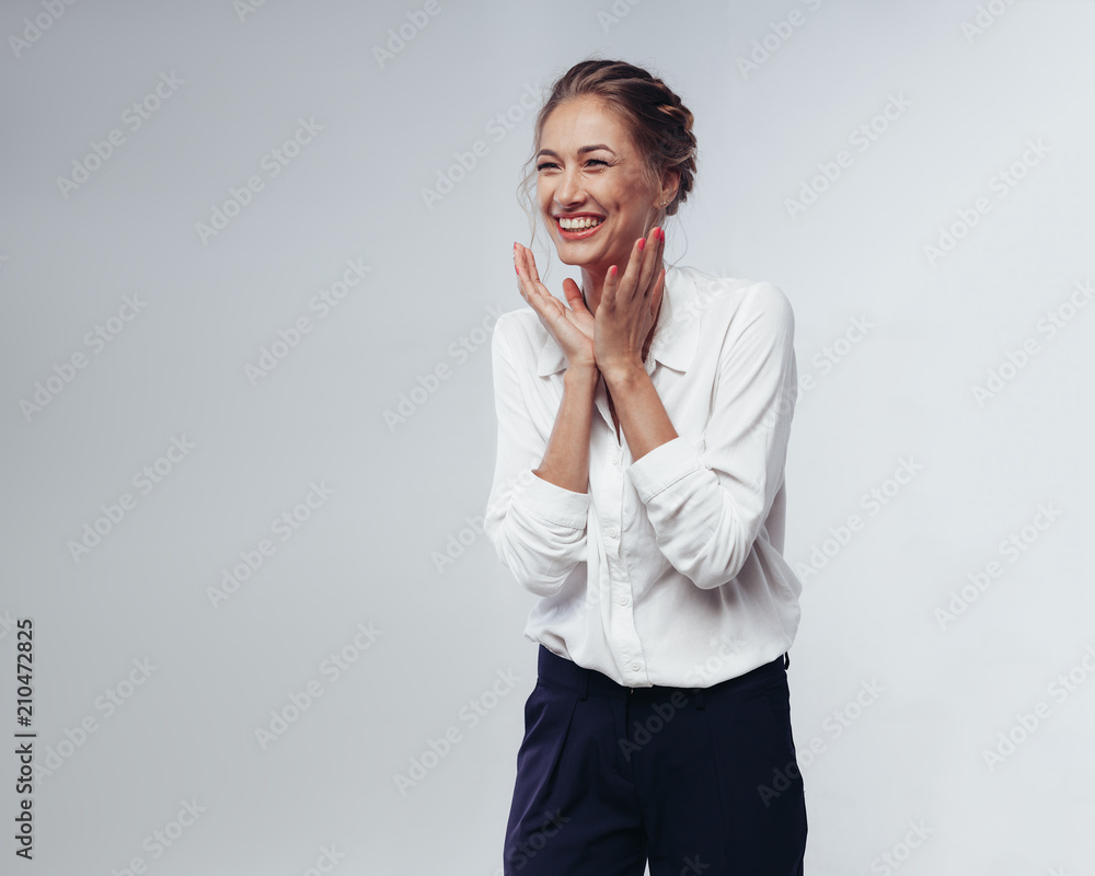 beautiful businesswoman in white blouse and black pants fun laughing and rejoicing at victory against white background in studio beautiful businesswoman in white blouse and black pants fun laughing and rejoicing at victory against white background in studio