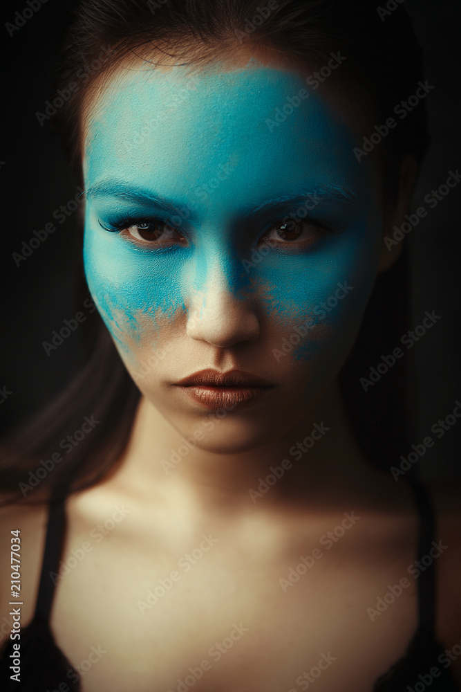 Beautiful asian girl is posing with creative blue makeup Beautiful asian girl is posing with creative blue makeup